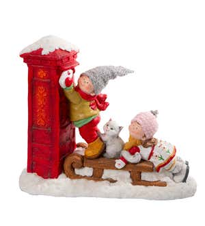 Boy and Girl on Sled with Cat Delivering Christmas Letter to Santa Claus