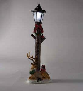 Solar Lighted Lamppost with Wreath, Deer and Presents Dusted with Snow