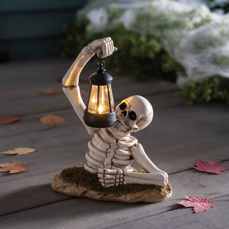 Solar Skeleton Groundbreaker Holding Lantern