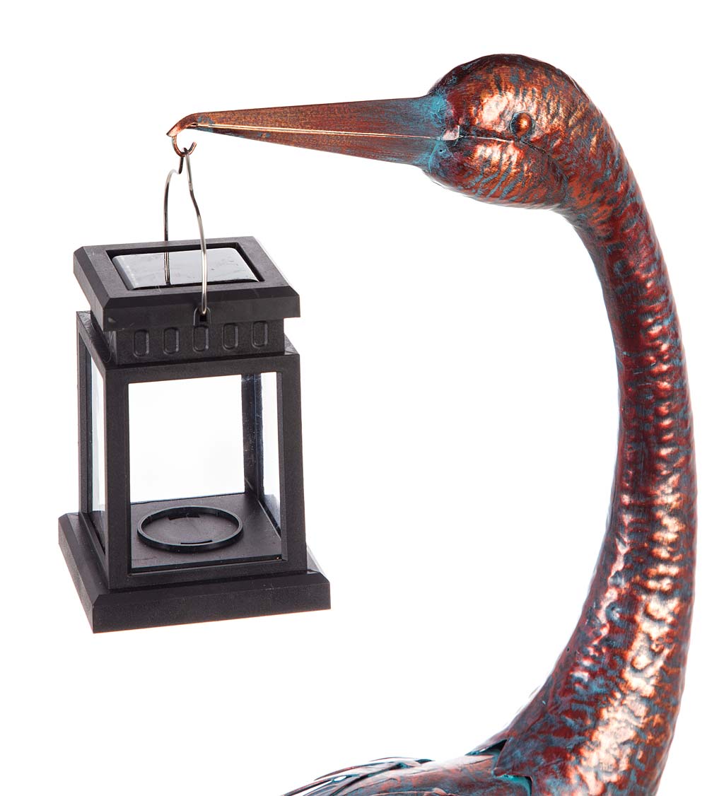 Standing Metal Crane with Antiqued Finish Holding a Solar Lantern
