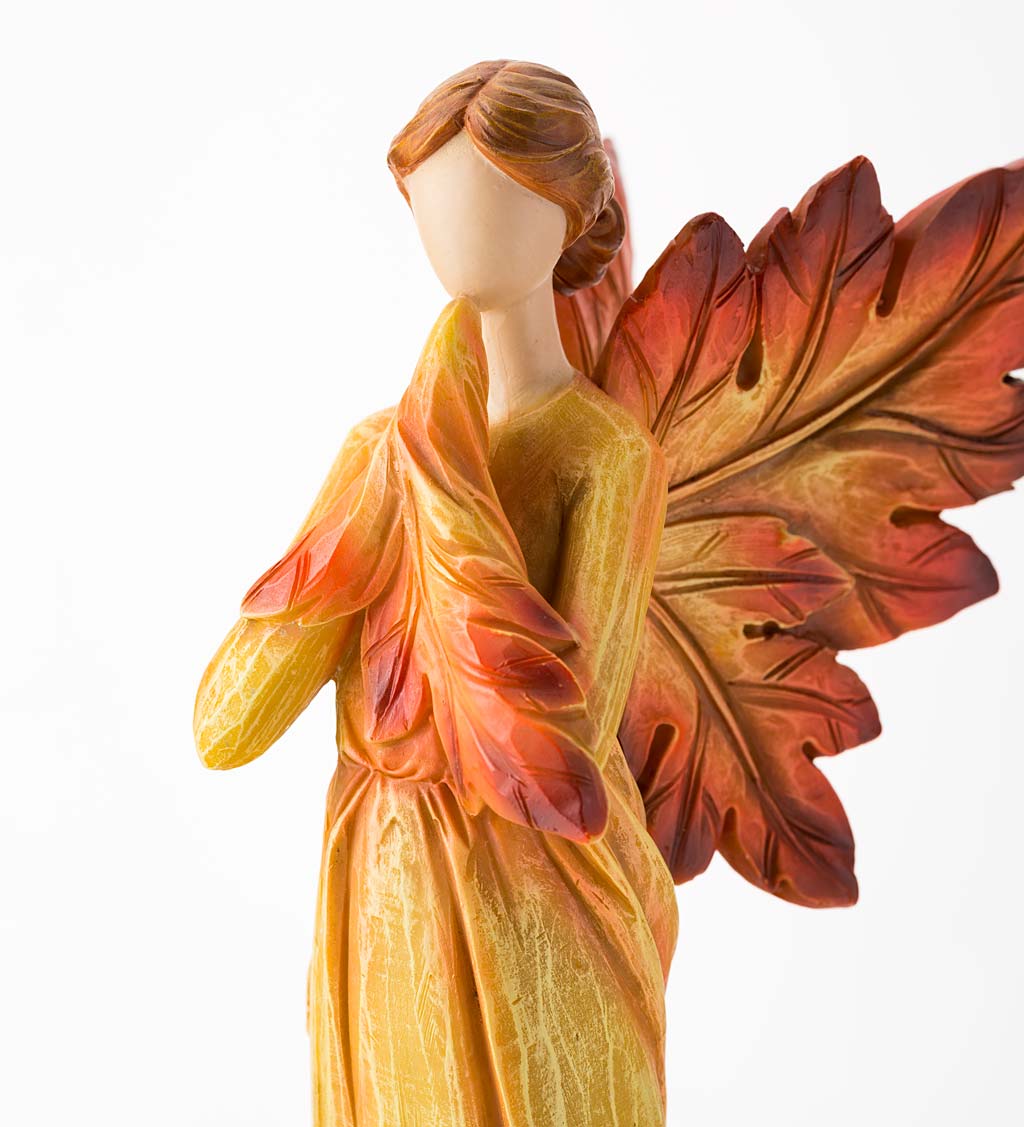 Standing Fall Angel with Leaf Wings and Fiery Hues of Autumn