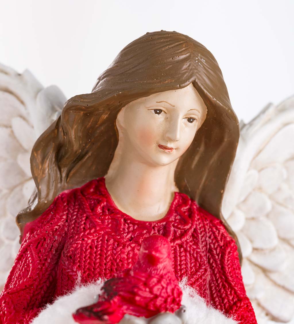 Holiday Angel In Long Faux-Fur Trimmed Coat Holding Cardinal