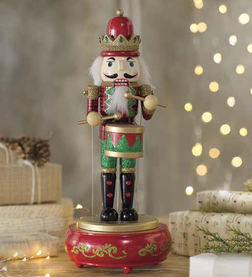 Image of a hand-painted musical wooden nutcracker figurine. Shop Tabletop Décor
