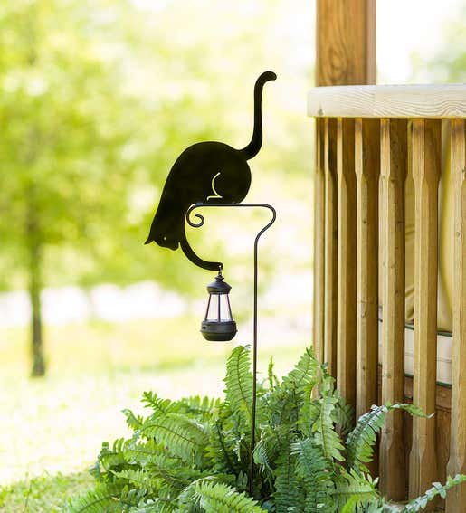 Image of a black cat silhouette garden stake holding a solar lantern. Shop Gifts for Cat & Dog Lovers