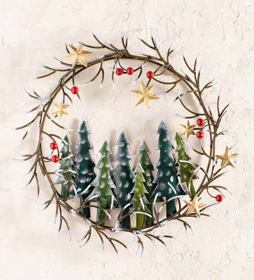 A metal holiday wreath with snowy pine trees and gold stars. Shop Holiday Wreaths & Flowers