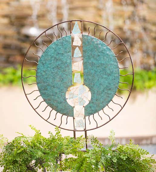 Lifestyle Image of Handcrafted Round Metal and Glass Garden Sculpture